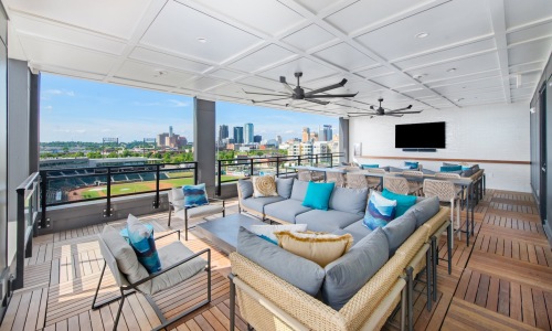 a lounge with a couch, tv and a view