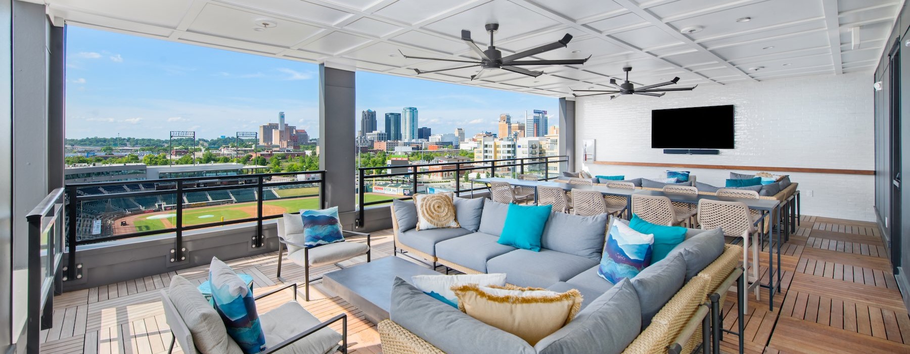 a lounge with a couch, tv and a view